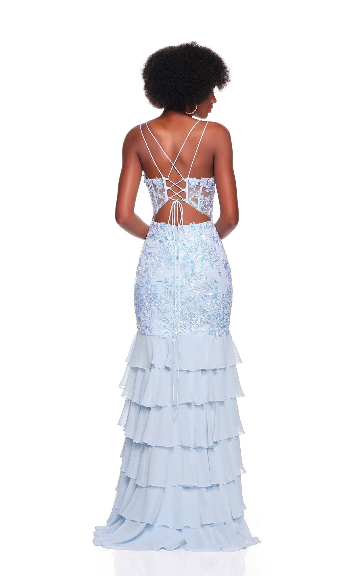 A woman stands against a white background wearing the Dave and Johnny 12671 long prom dress—light blue chiffon with a lace bodice, lace-up back, and tiered ruffle skirt.
